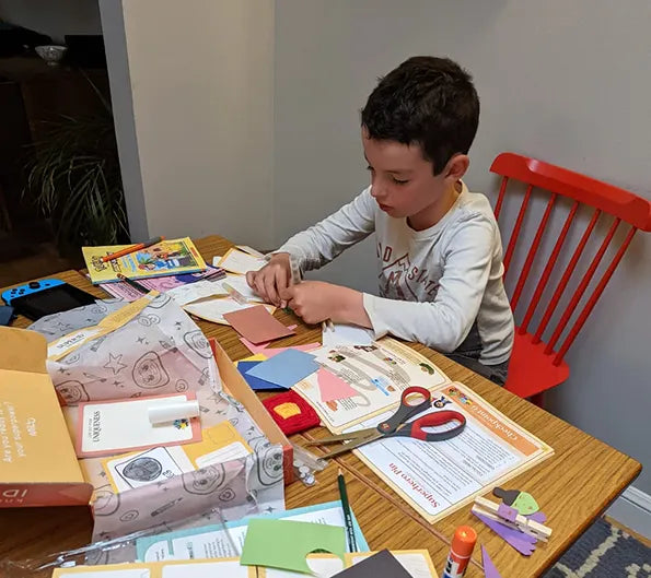 Boy at a table doing crafts
